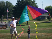 Fort Wayne back pain free grandpa and grandson playing with a kite